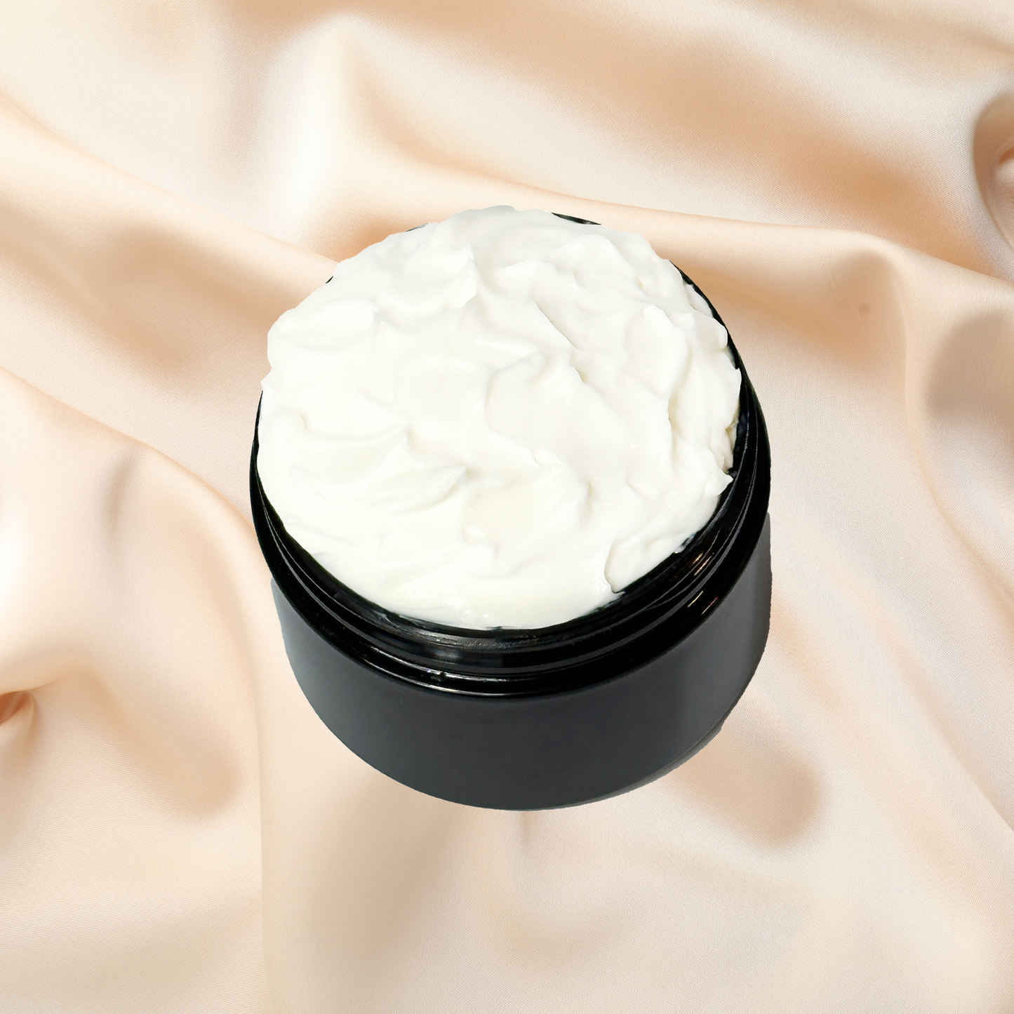 Black jar of white cream on a beige fabric background