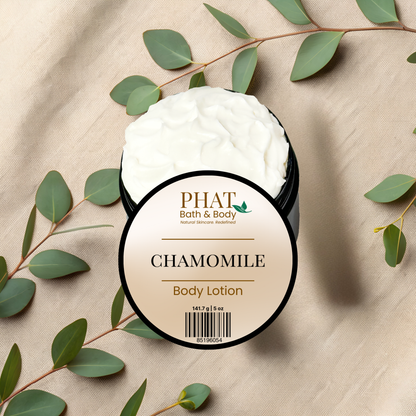 Body lotion container with 'PHAT Bath & Body' branding on a beige fabric background with green leaves.