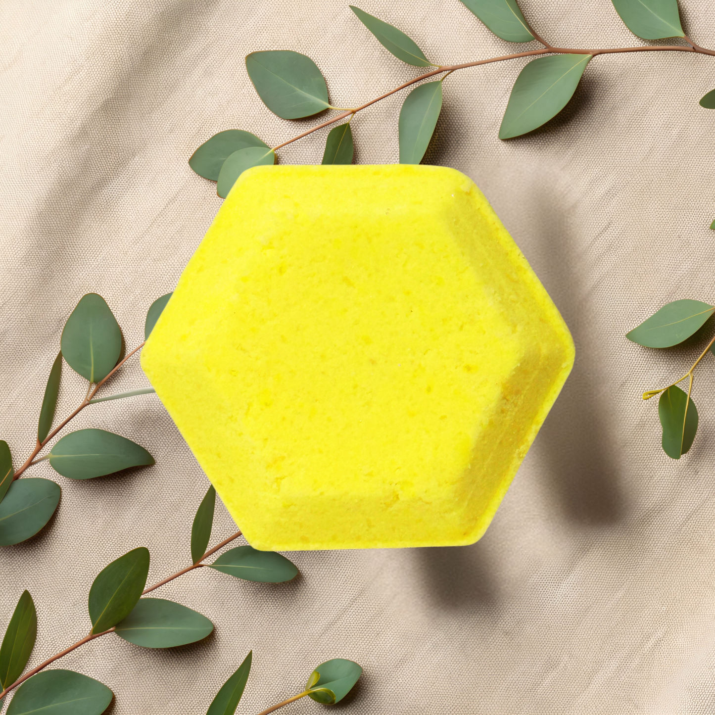 Hexagonal yellow steamer with green leaves on a beige fabric background