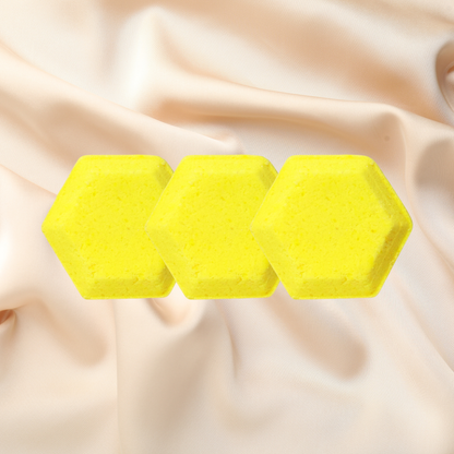 Three yellow hexagonal steamers on a beige fabric background