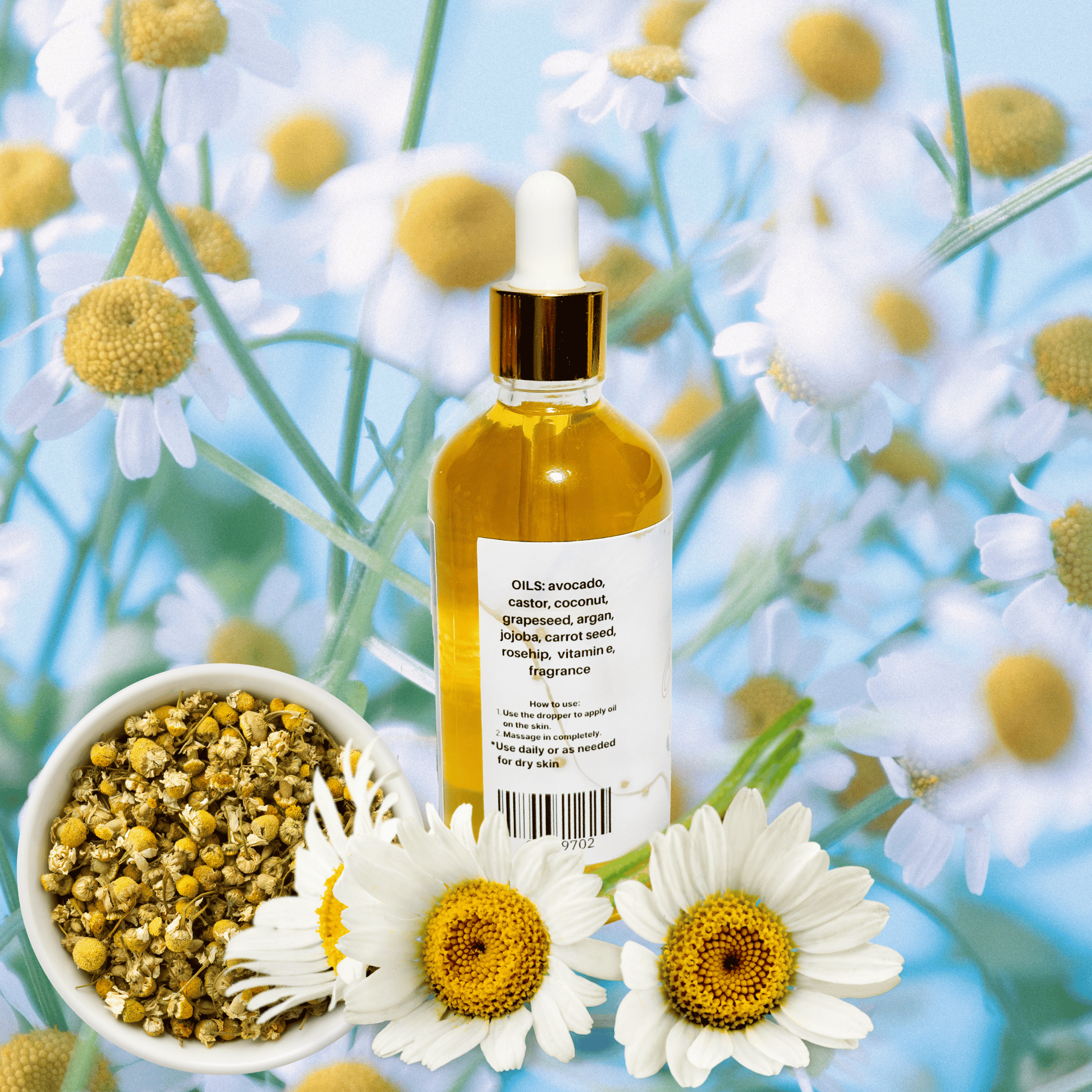 Bottle of essential oil with flowers and herbs on a light blue background