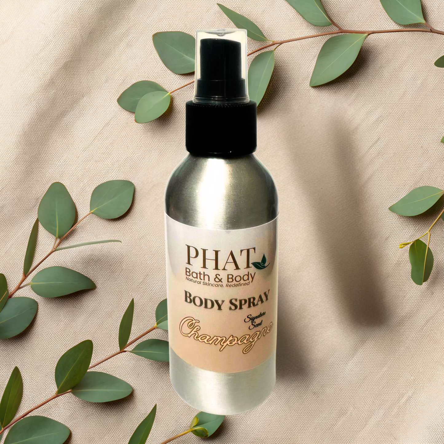 Body spray bottle with 'PHAT Bath & Body' label on a textured beige background