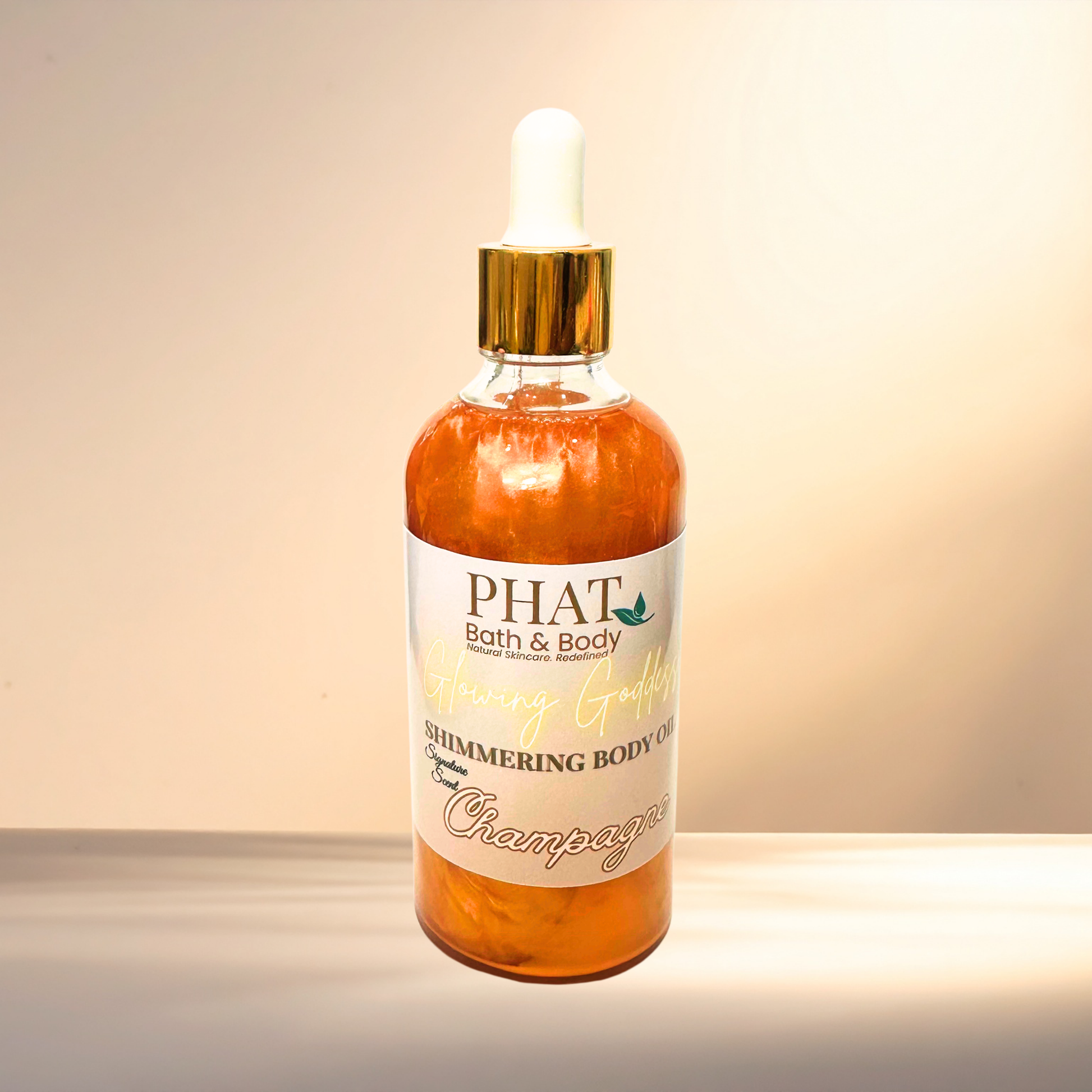 Bottle of 'PHAT Bath & Body' shimmering body oil on a gradient background