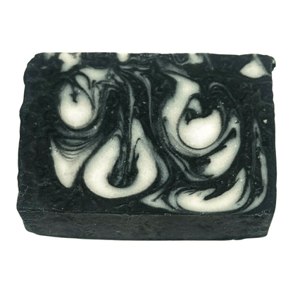 Black and white swirled charcoal soap bar on a white background