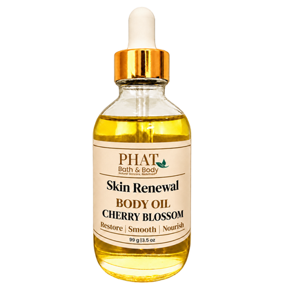 Phat Bath & Body Cherry Blossom Skin Renewal Body Oil, 3.5 oz golden body oil in a clear glass dropper bottle with a gold cap and cream label.