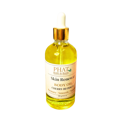 Bottle of Phat Bath & Body Skin Renewal Body Oil with cherry blossom scent on a white background