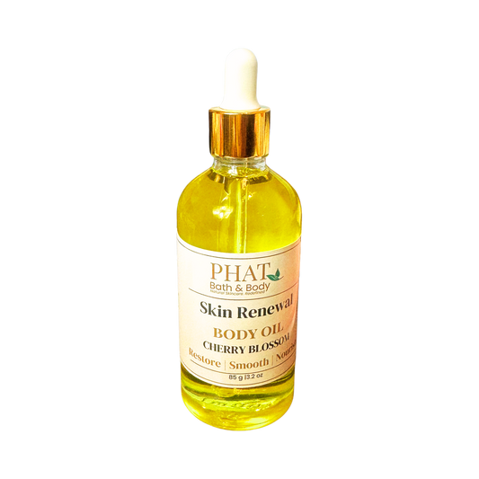 Bottle of Phat Bath & Body Skin Renewal Body Oil with cherry blossom scent on a white background