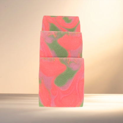 Colorful soap bar with pink and green swirls on a neutral background