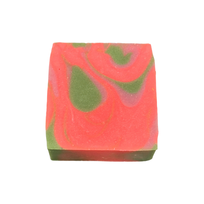 Colorful soap bar with pink and green swirls on a white background
