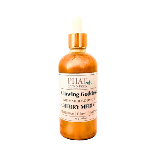 Bottle of 'Glowing Goddess' shimmer body oil by Phat Bath & Body on a white background