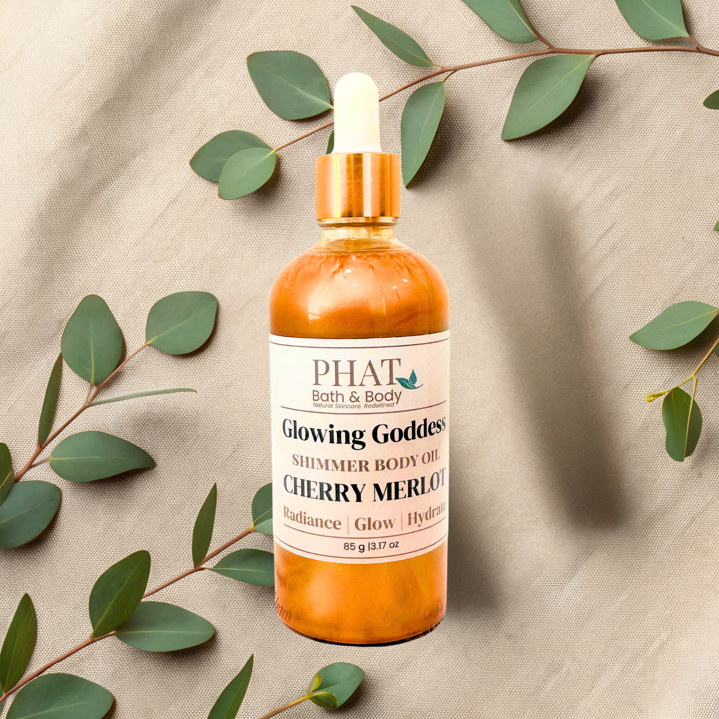 Bottle of 'Cherry Merlot' by PHAT Bath & Body on a beige fabric background with green leaves.