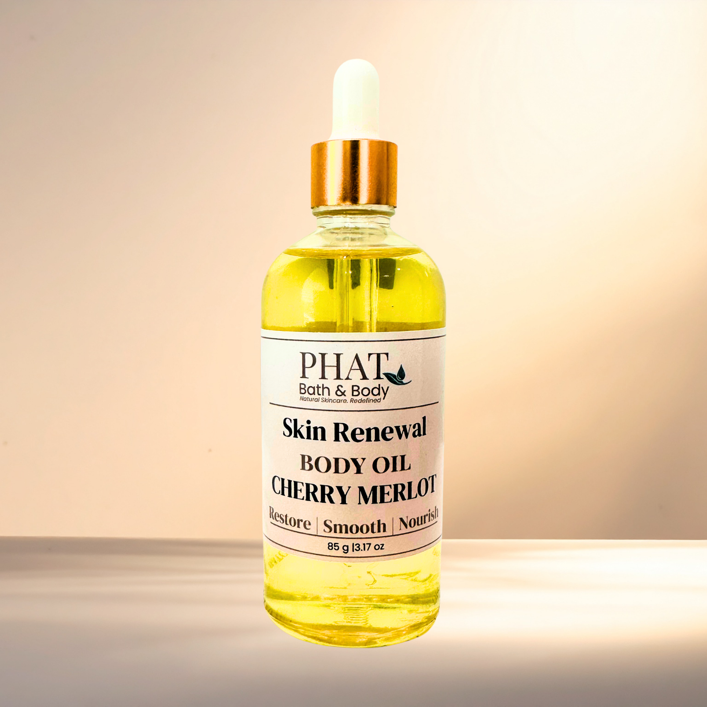 Bottle of Phat Bath & Body Skin Renewal Body Oil Cherry Merlot on a gradient background