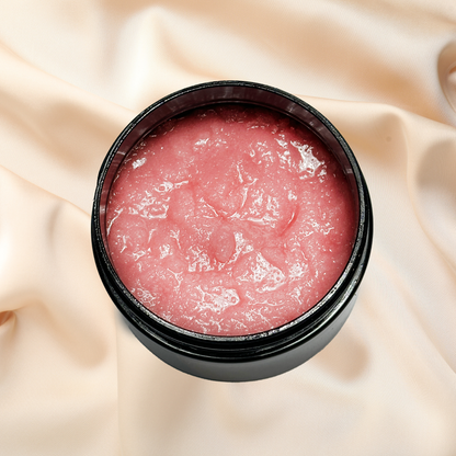 Pink scrub in a black container on a beige fabric background