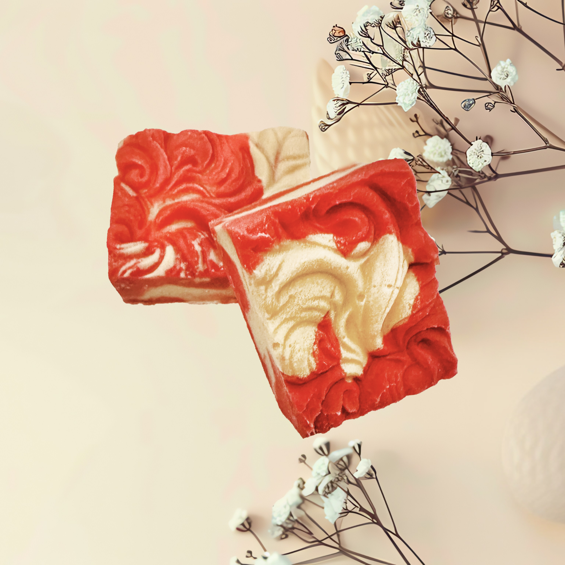 Red and beige soap bars with decorative elements on a light background