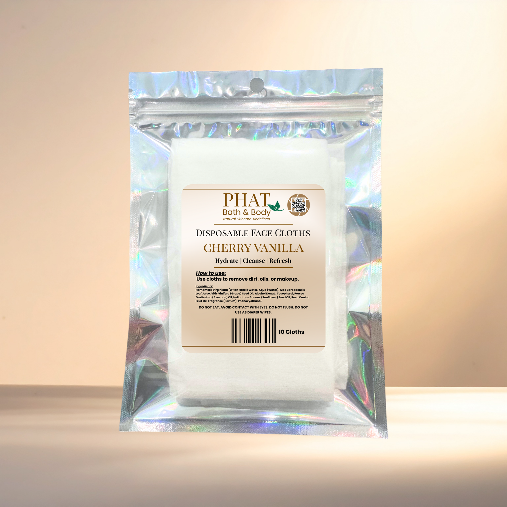 Packaged disposable face cloths with cherry blossom scent by Phat Bath & Body on a neutral background.
