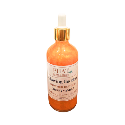 Bottle of 'Glowing Goddess' shimmer body oil by Phat Bath & Body on a white background