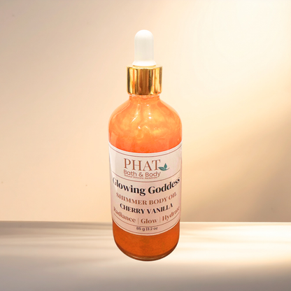 Bottle of PHAT Bath & Body Glowing Goddess Shimmer Body Oil on a gradient background