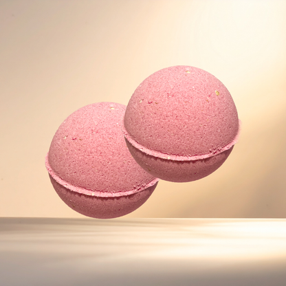 Two pink bath bombs on a beige background