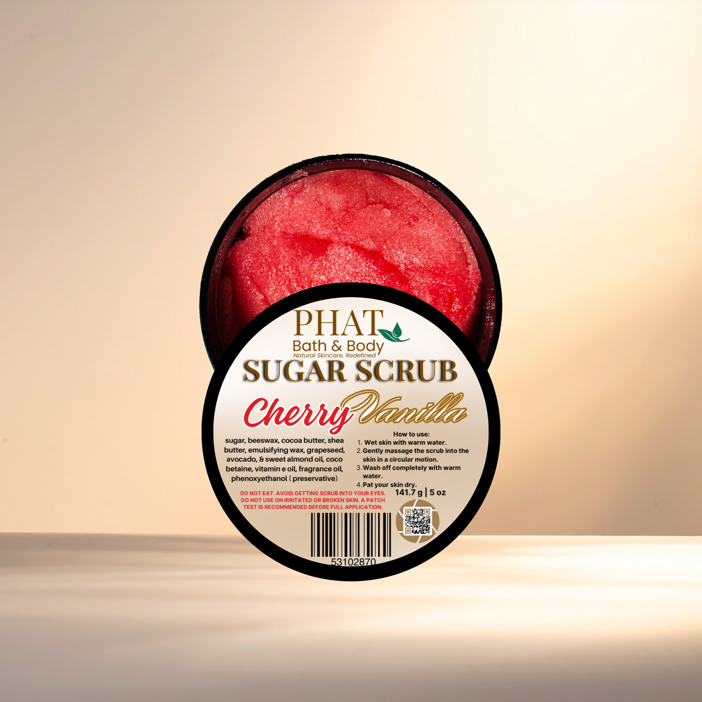 Container of cherry vanilla sugar scrub with 'Phat Bath & Body' branding on a beige background