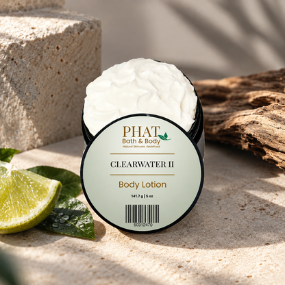 Clearwater II Men’s Body Lotion displayed with fresh citrus, smooth stone, warm driftwood, and a clean sunlit coastal setting.