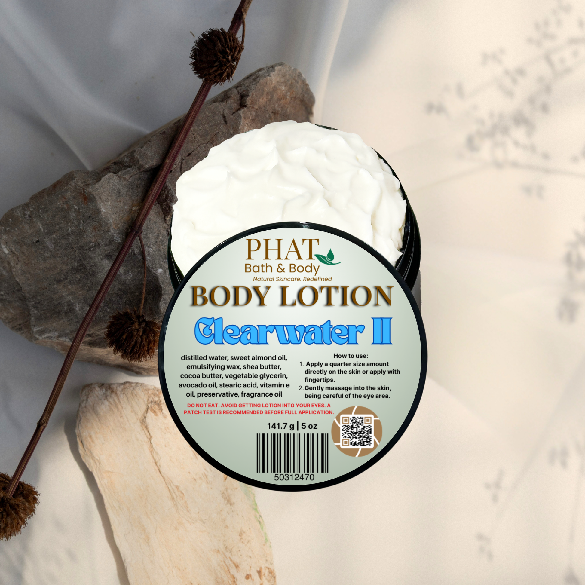 Body lotion container labeled 'Clearwater II' by Phat Bath & Body on a natural stone background.