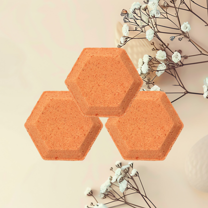 Three hexagonal steamers on a light surface with white flowers and branches.