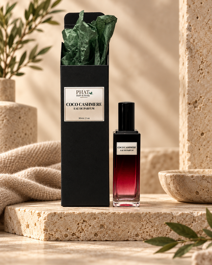 Coco Cashmere unisex Eau de Parfum bottle with black gift box and green tissue in a warm luxury setting.