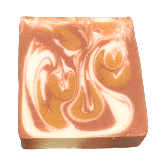 Coco Cashmere handmade clay soap by Phat Bath & Body featuring caramel brown, golden tan, and creamy white marbled swirls on a rectangular bar with a transparent background.