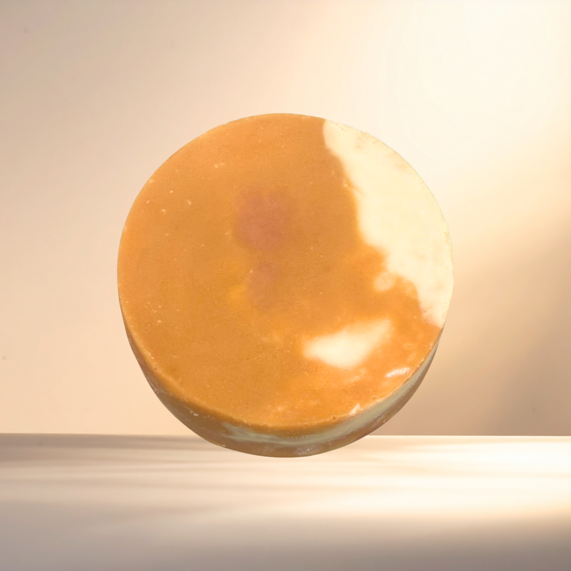 Round brown soap bar on a light background