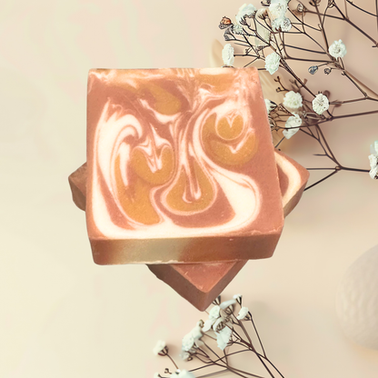 Two swirled soap bars with a neutral background