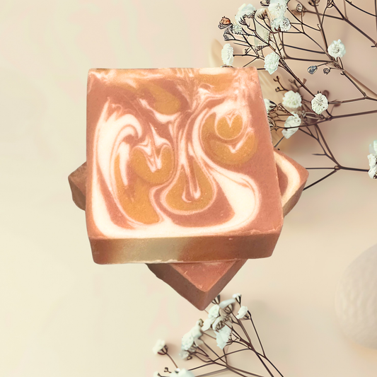 Two swirled soap bars with a neutral background