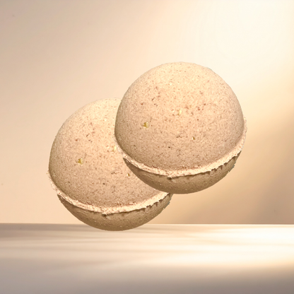 Two beige bath bombs on a neutral background