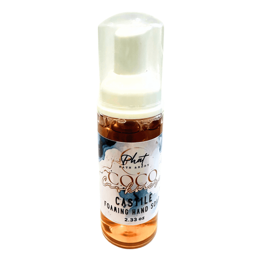 Bottle of Castile foaming hand soap with a white cap on a white background
