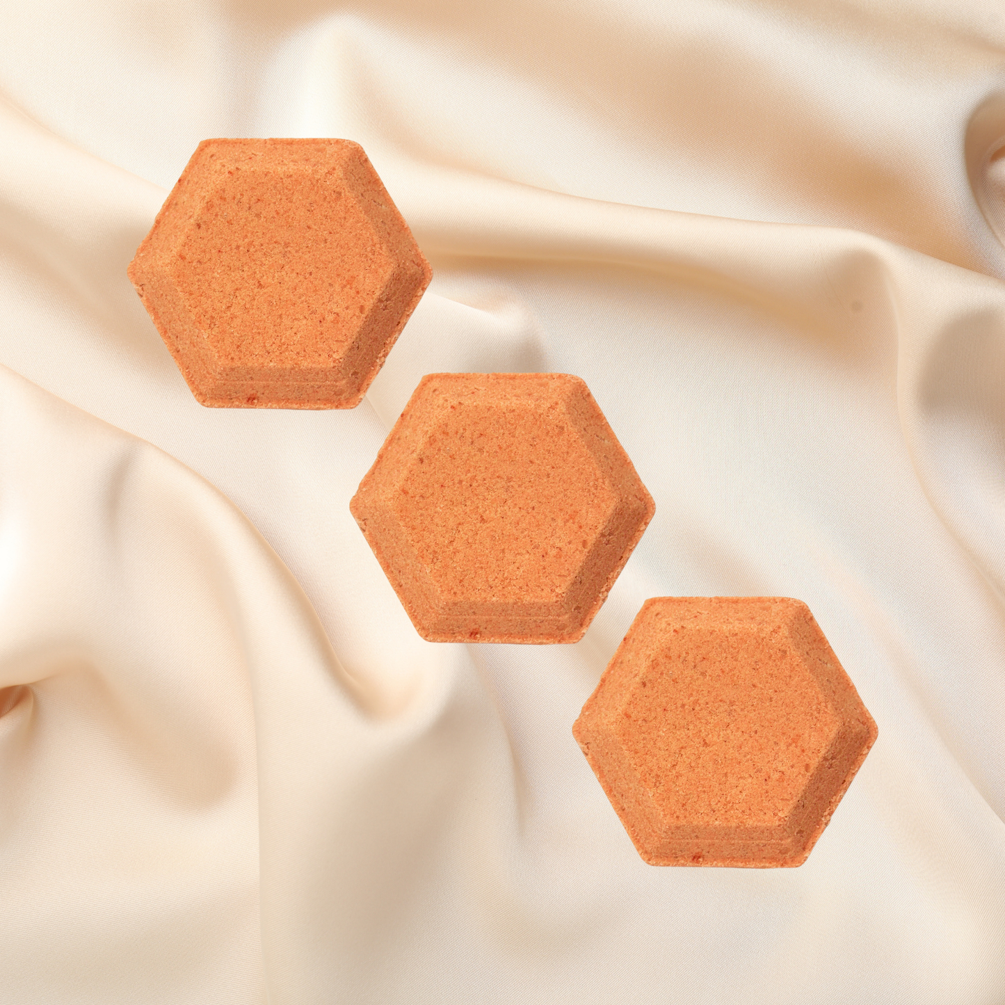 Hexagonal shower bombs on a beige fabric background