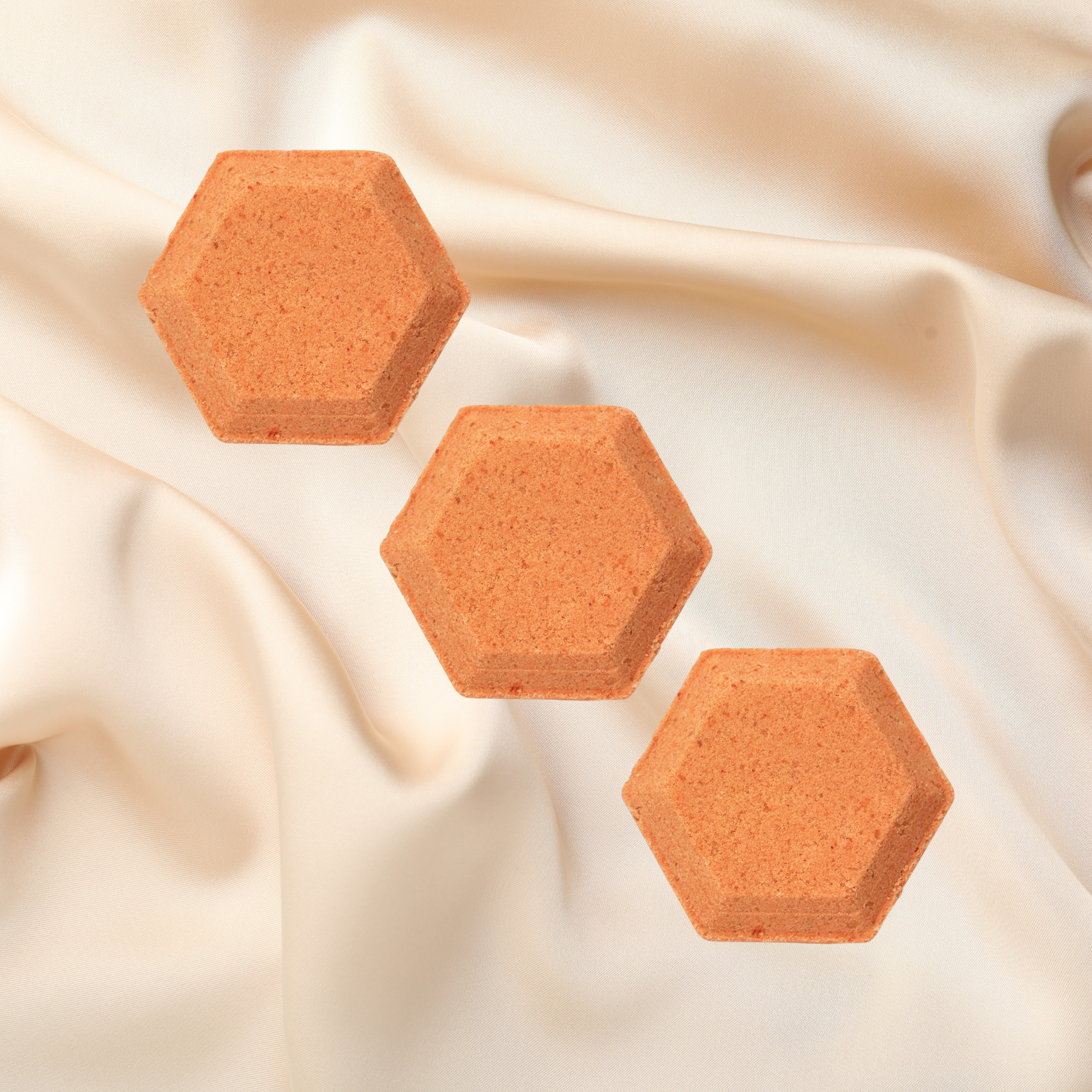 Hexagonal shower bombs on a beige fabric background
