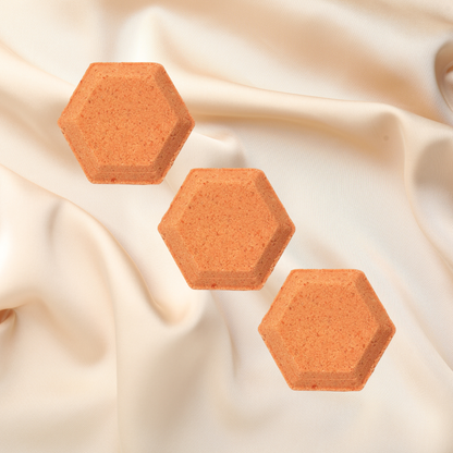 Hexagonal shower bombs on a beige fabric background