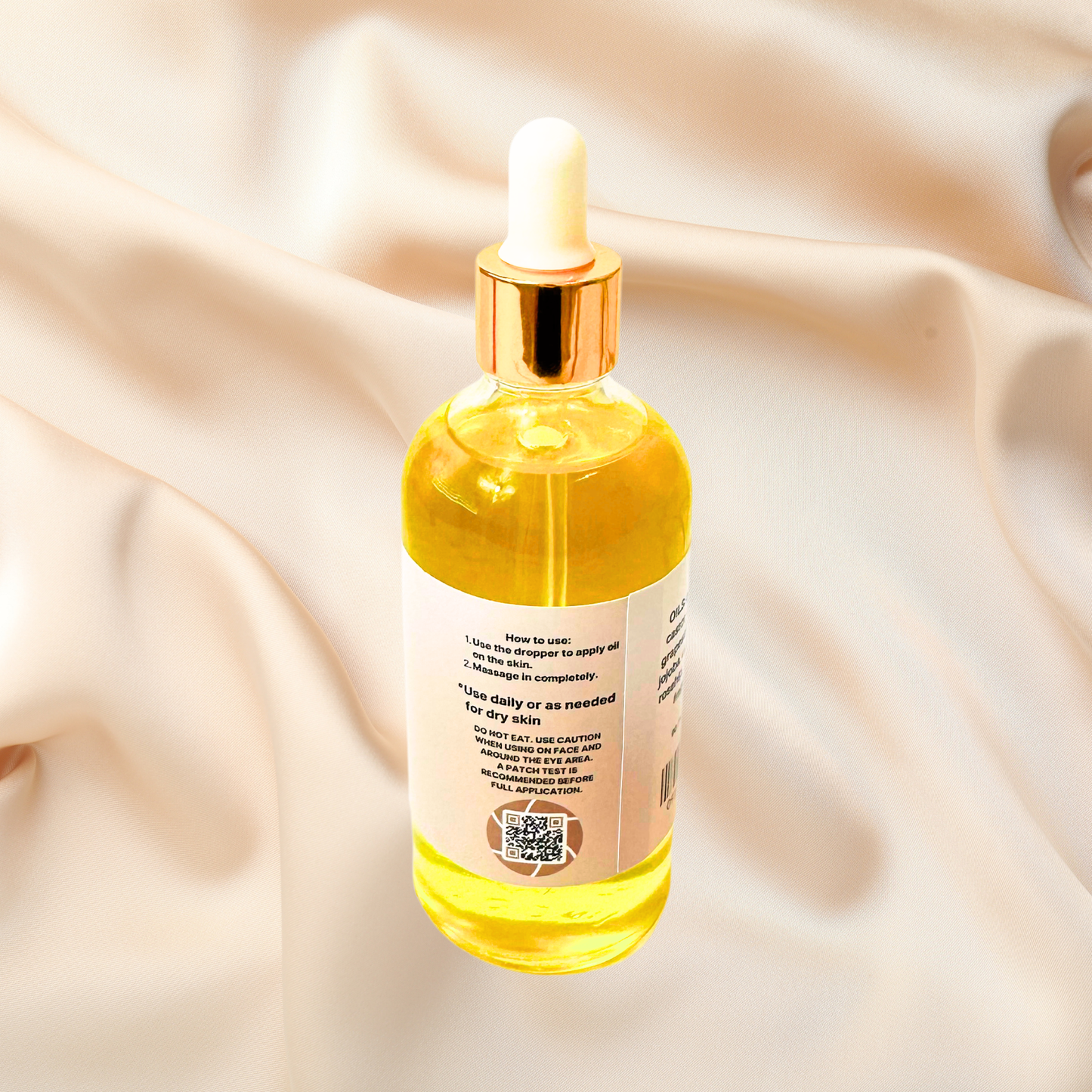 Bottle of yellow liquid with dropper on a beige fabric background