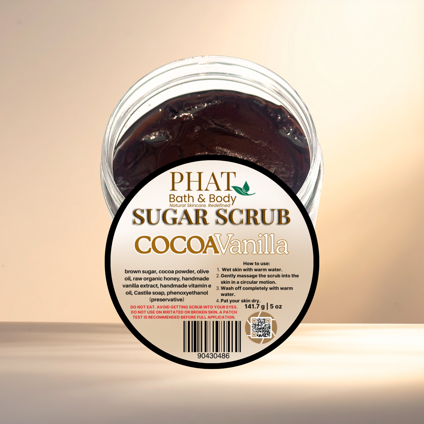 Jar of Phat Bath & Body Cocoa Vanilla sugar scrub on a beige background
