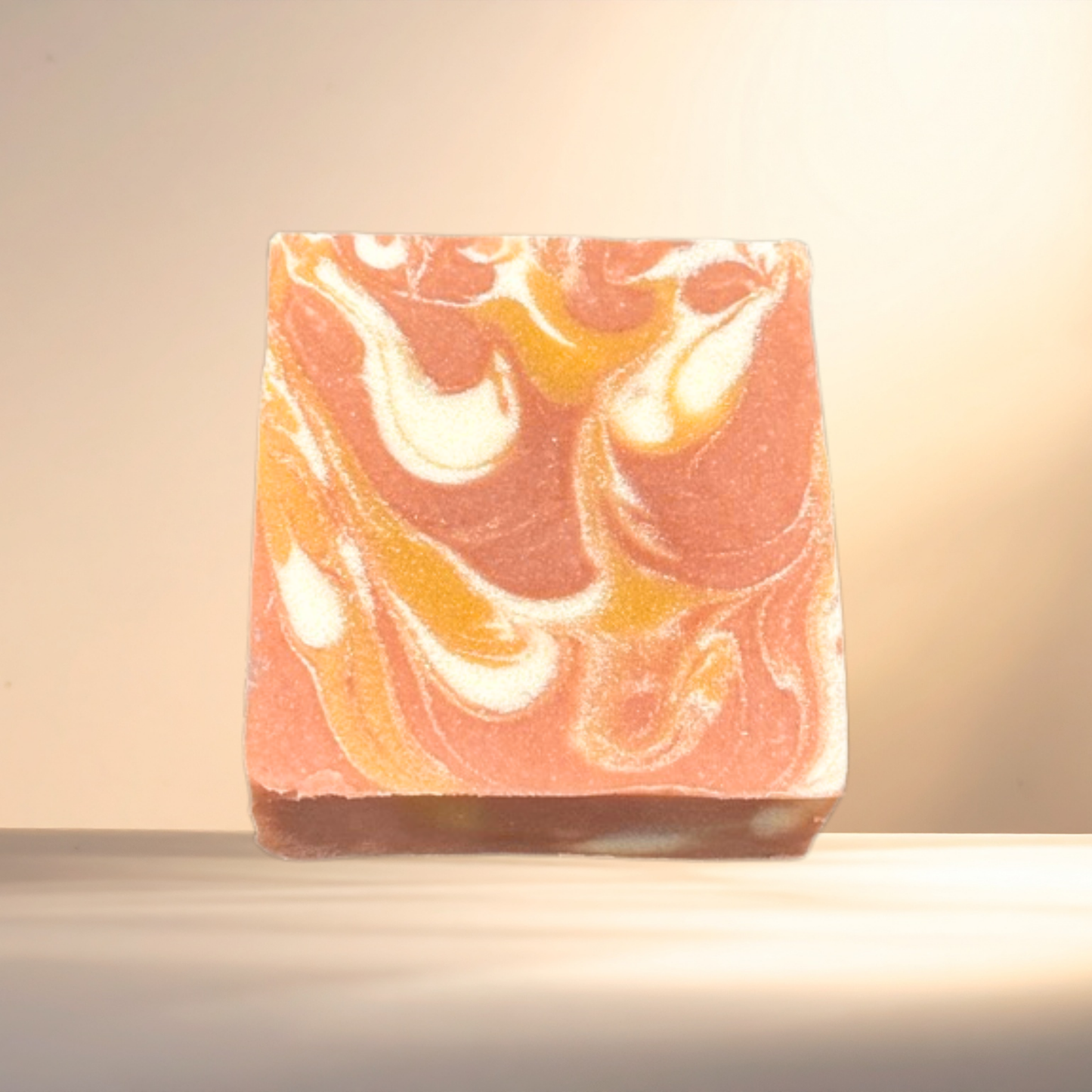 Marbled soap bar with orange, white, and brown colors on a neutral background