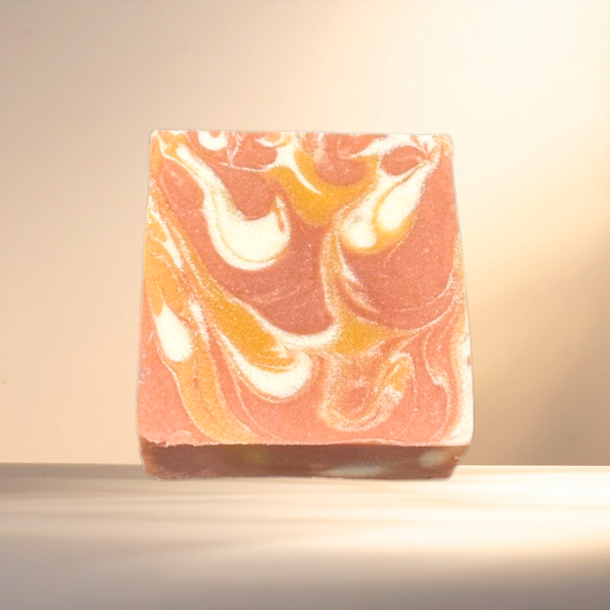 Marbled soap bar with orange, white, and brown colors on a neutral background