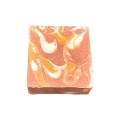 Bar of soap with orange and white swirl pattern on a white background