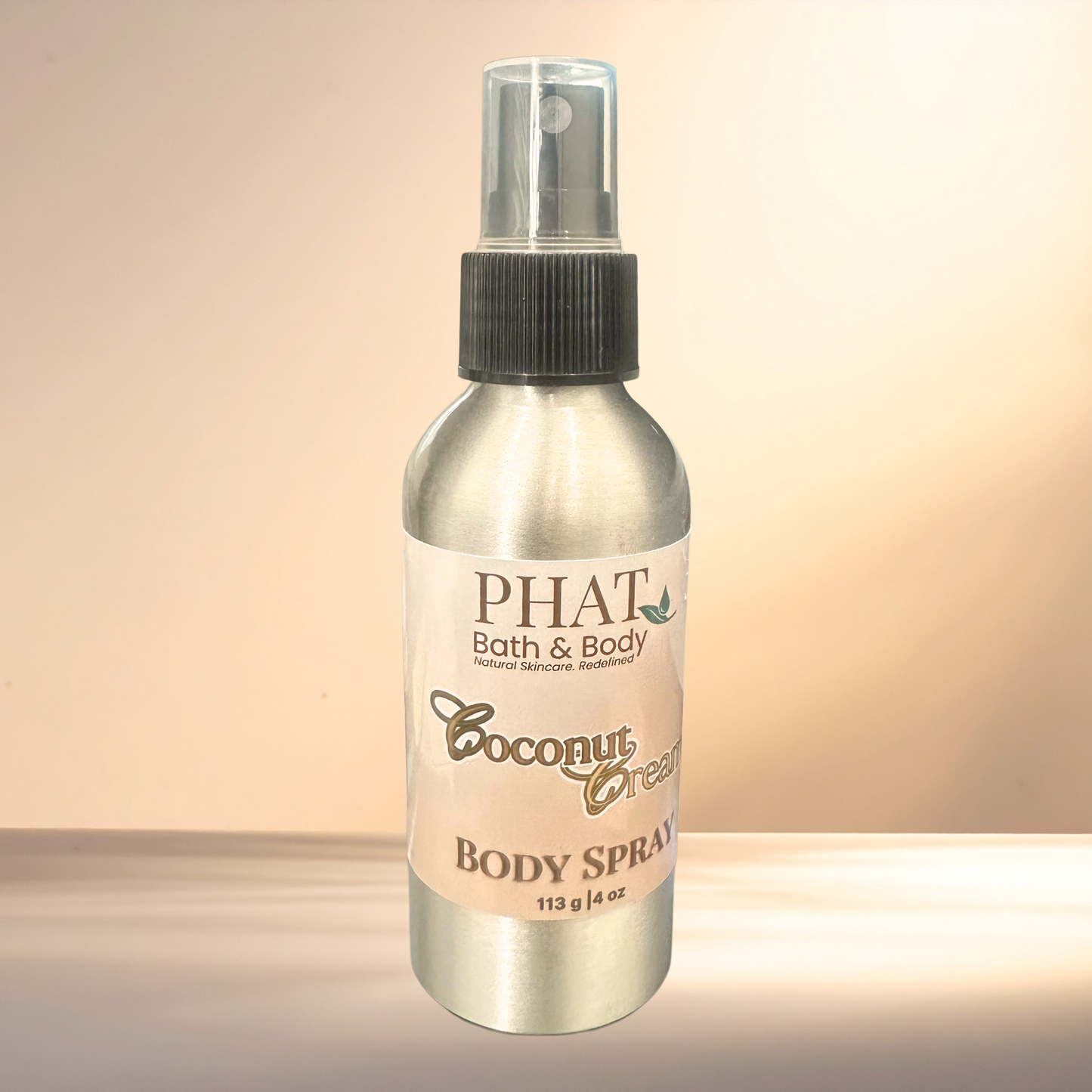 Body spray bottle labeled 'PHAT Bath & Body Coconut Cream' on a gradient background