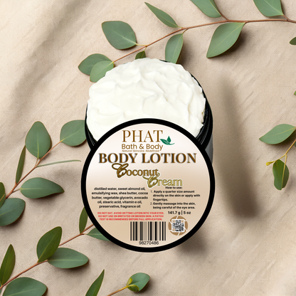 Body lotion container labeled 'Coconut Cream' by Phat Bath & Body on a beige fabric background with green leaves.