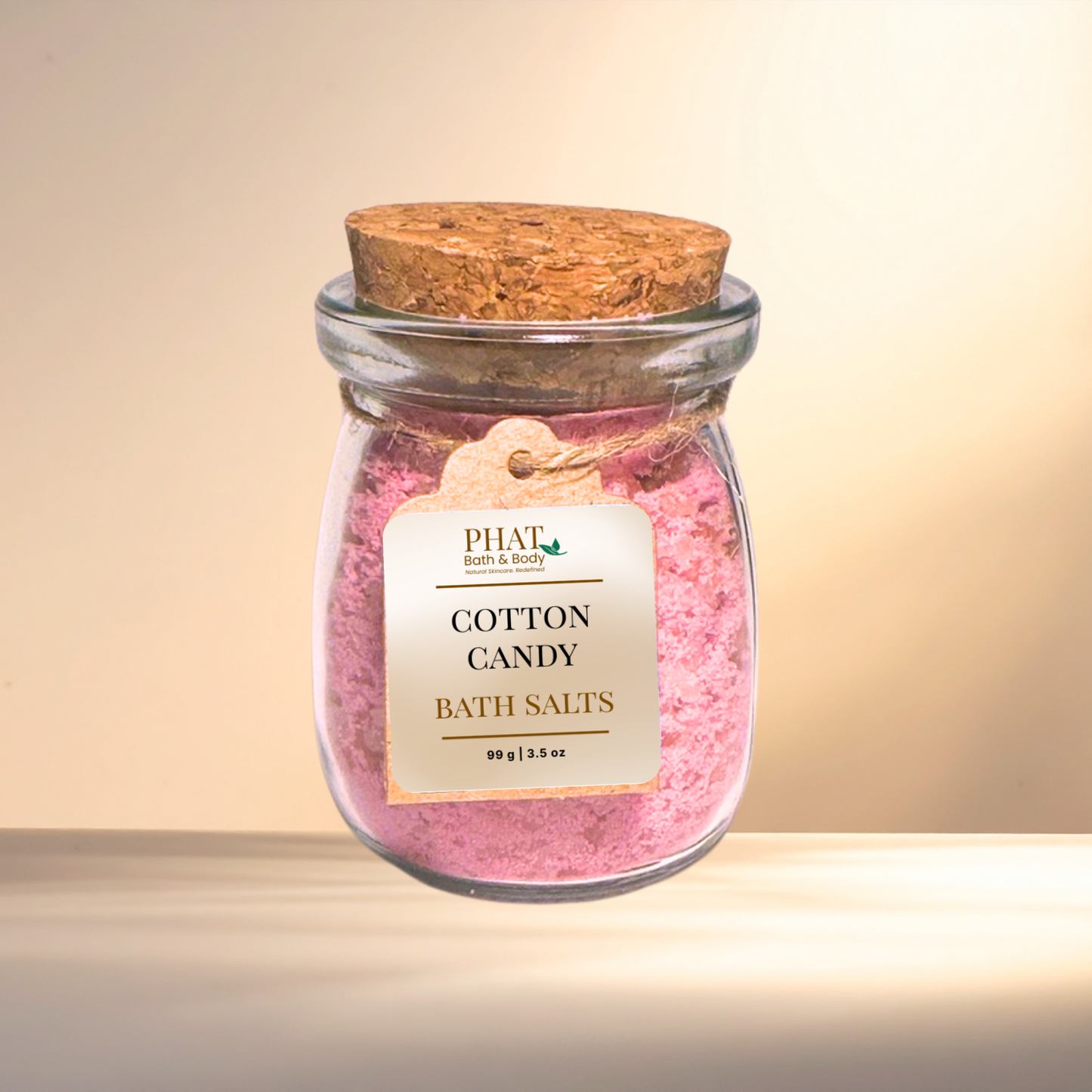 Jar of cotton candy bath salts with a cork lid on a gradient background