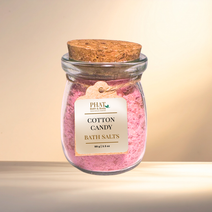 Jar of cotton candy bath salts with a cork lid on a gradient background