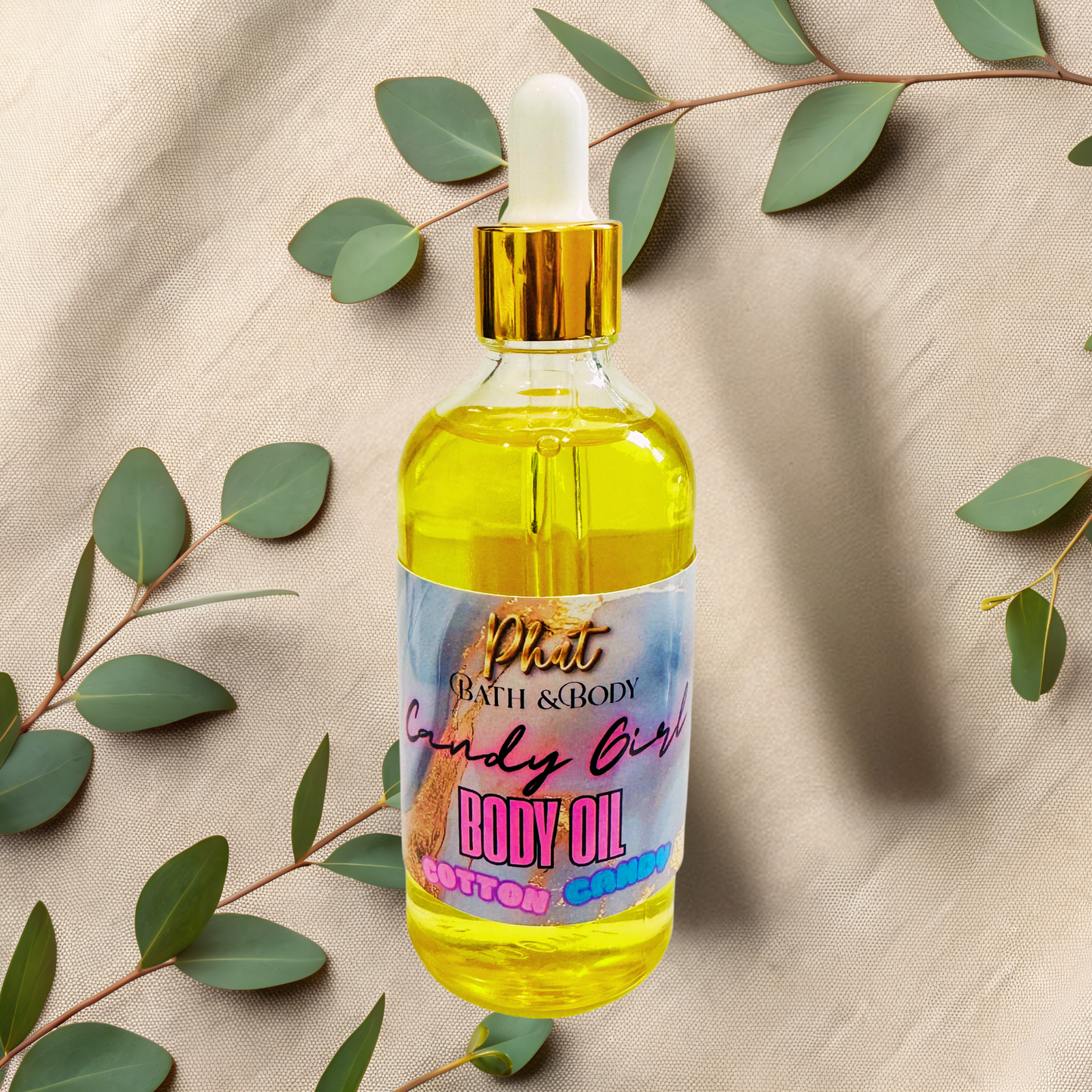 Bottle of body oil with a dropper on a beige fabric background with green leaves.