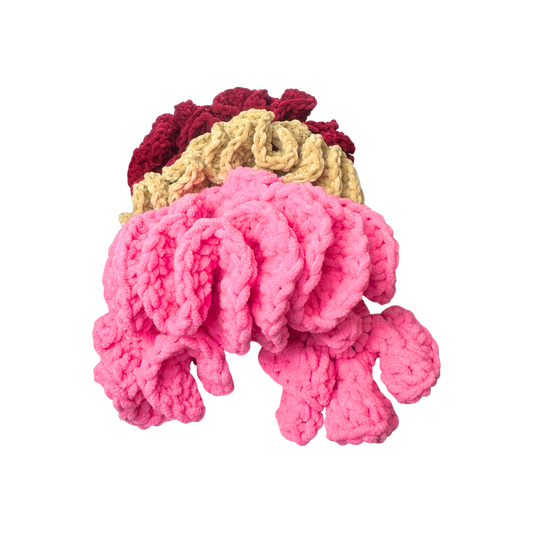 Crocheted headbands with pink, tan, and red colors on a white background