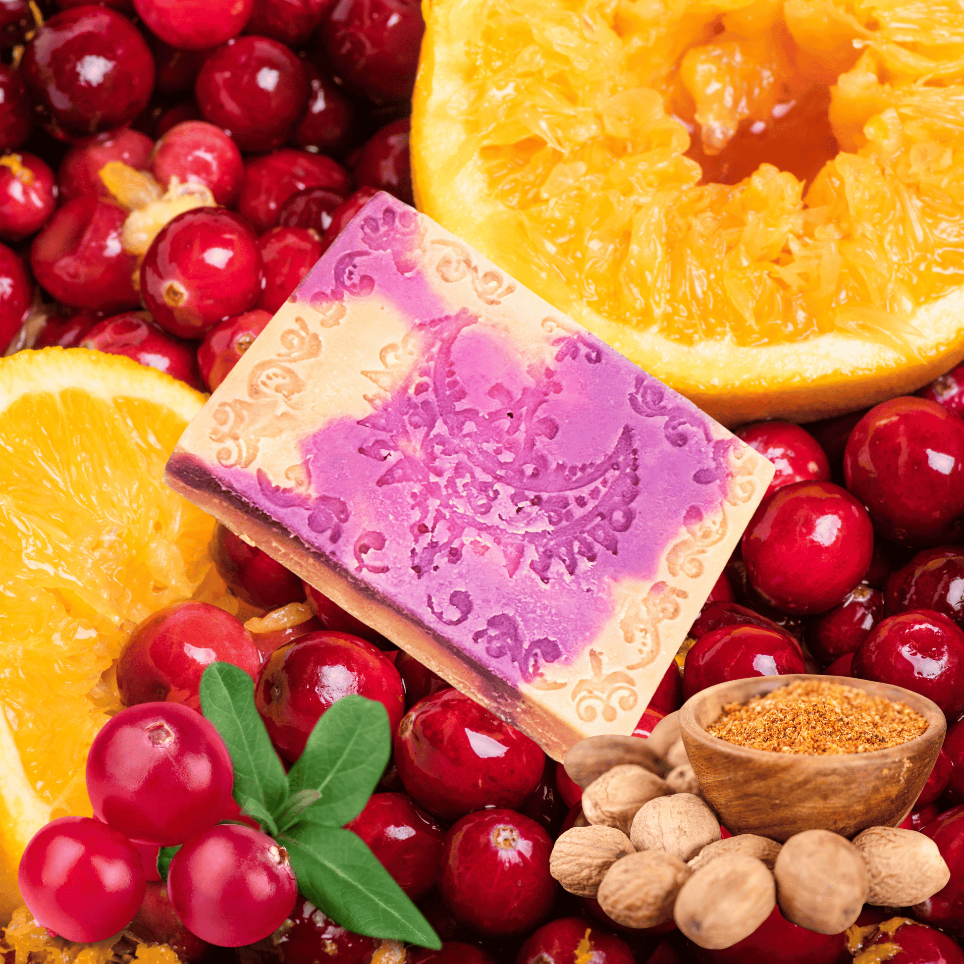 Purple and orange soap bar with orange slices and cranberry background.