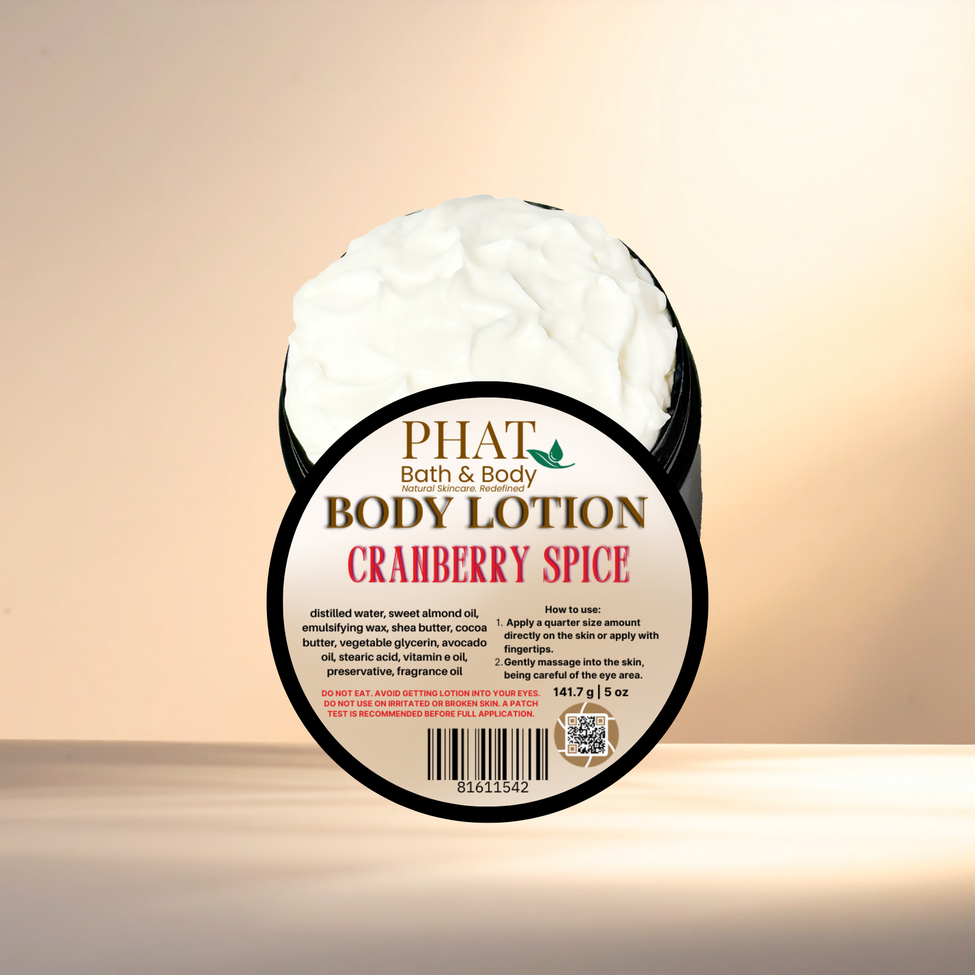 Body lotion container labeled 'PHAT Bath & Body Cranberry Spice' on a gradient background
