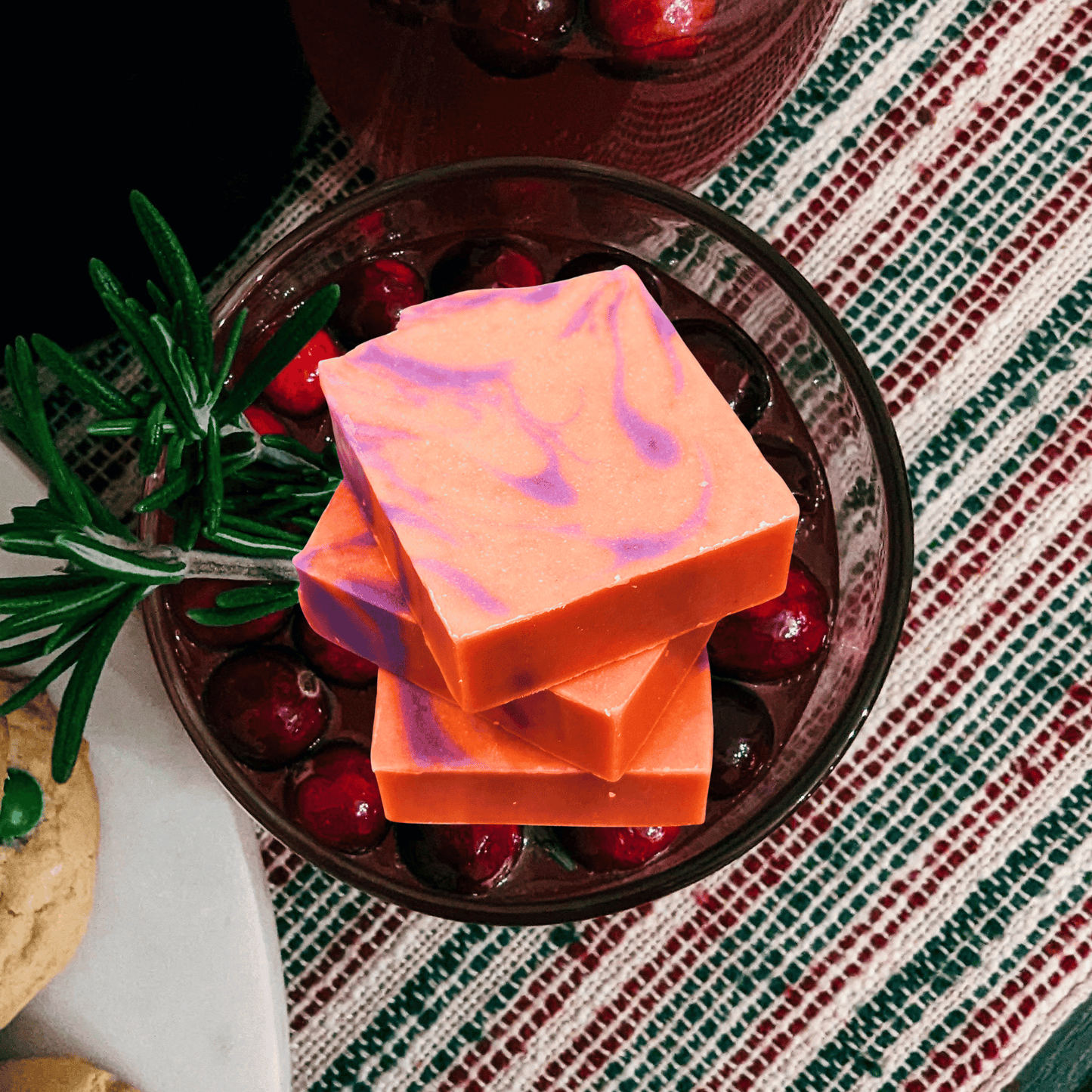 orange and purple bar soap in a bowl of cranberry sauce.
